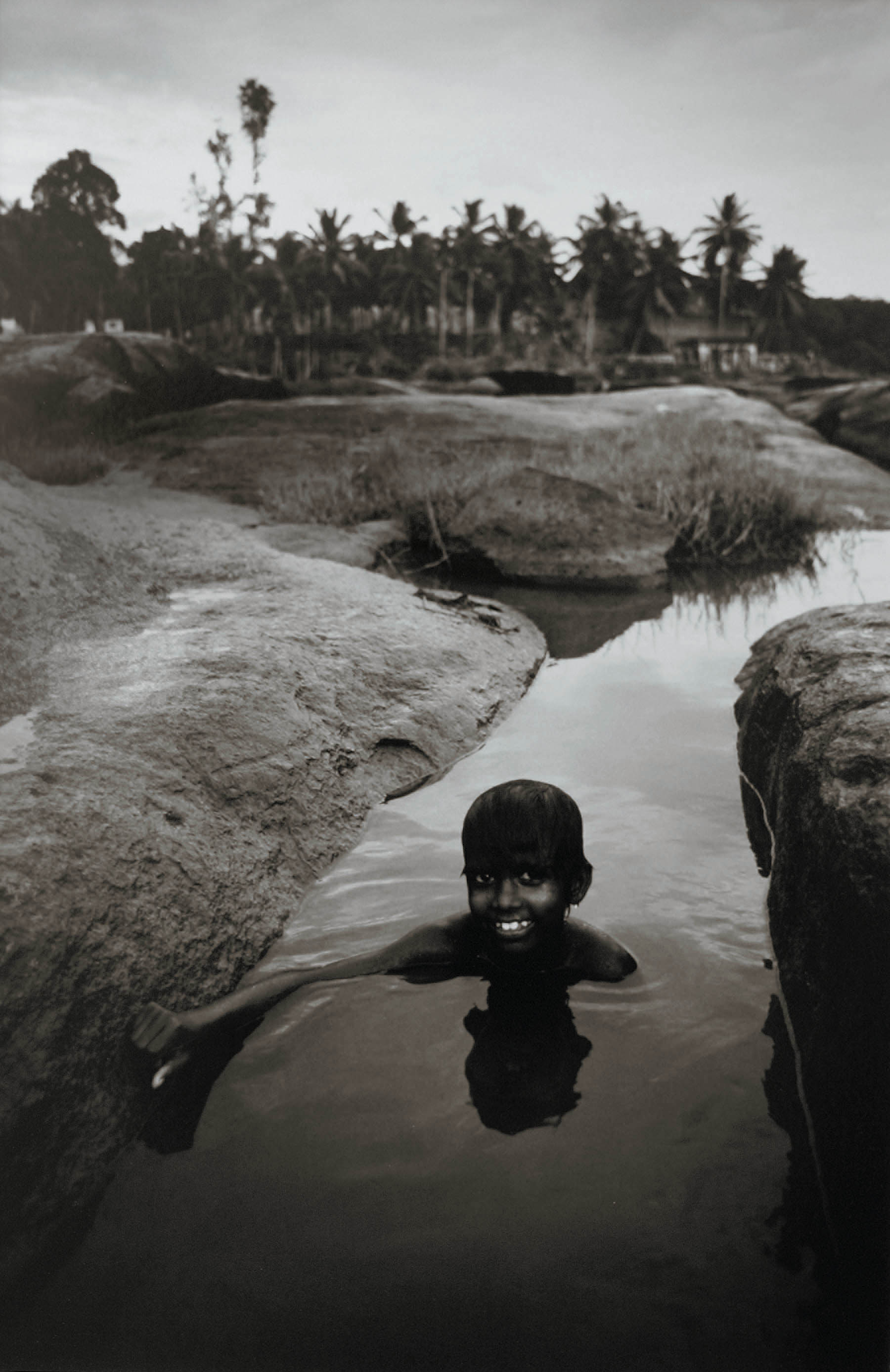 Boy swimming, Kerala, South India